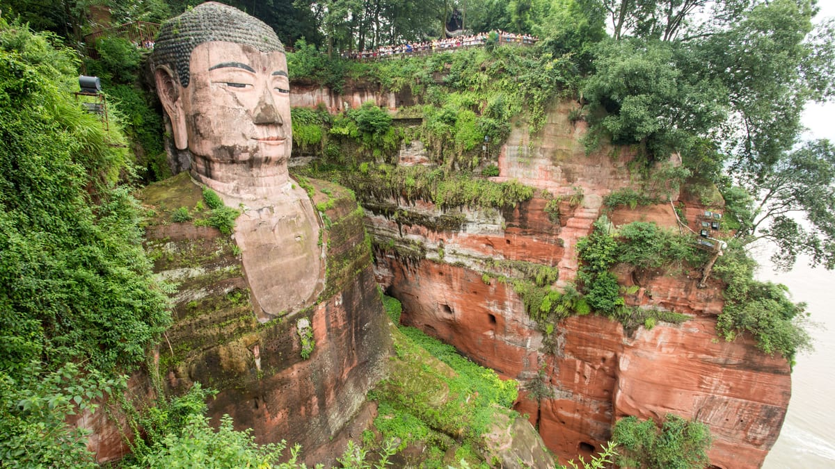 The Leshan Giant Buddha, a colossal stone Buddha carved into a red-sandstone cliff near Chengdu