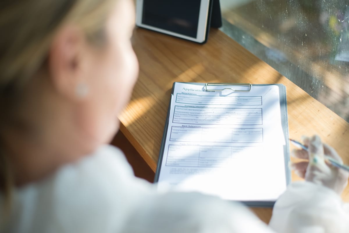 Filling out a visa application form by hand