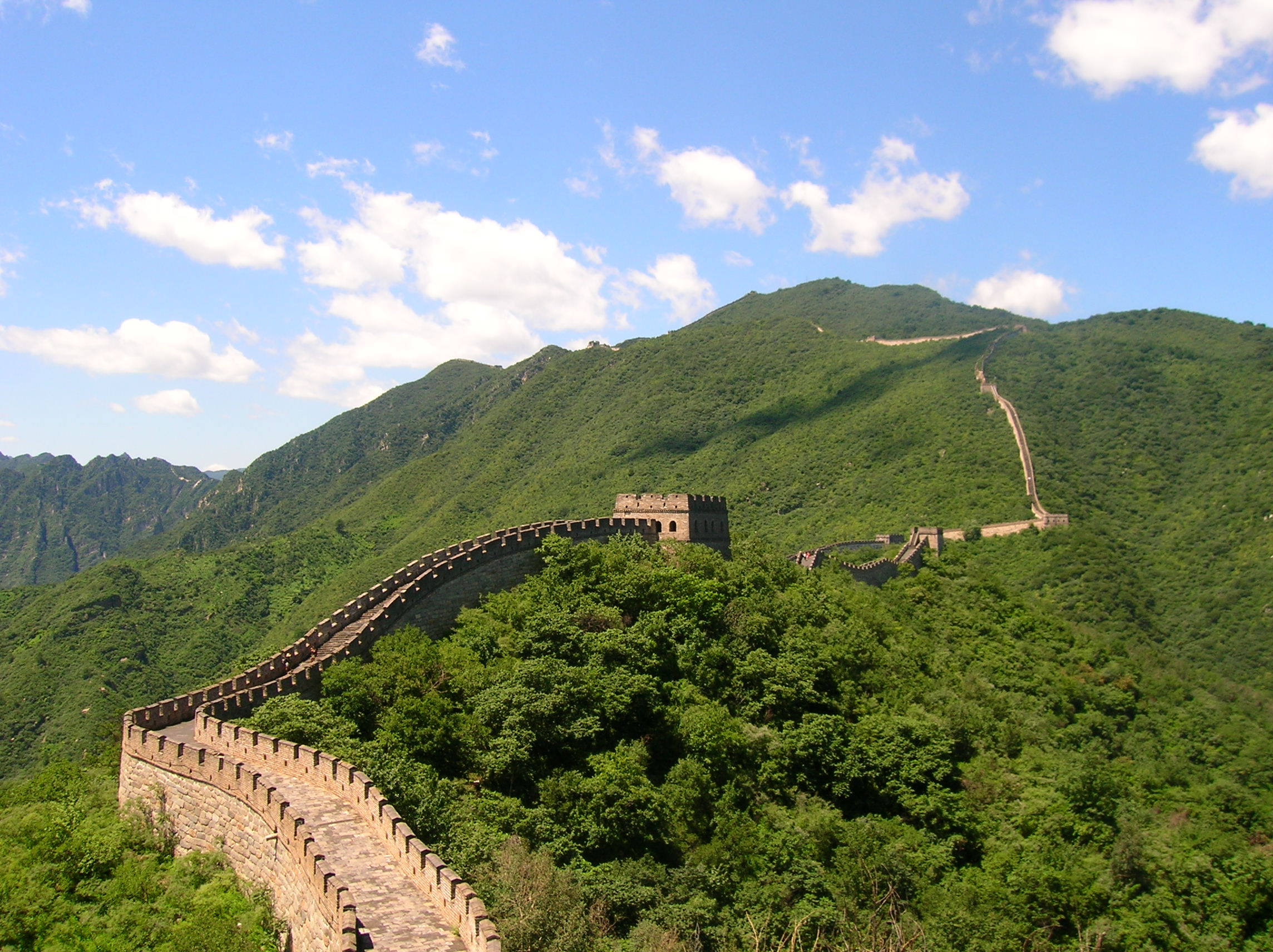 The restored Mutianyu section of the Great Wall winding over forested ridges near Beijing
