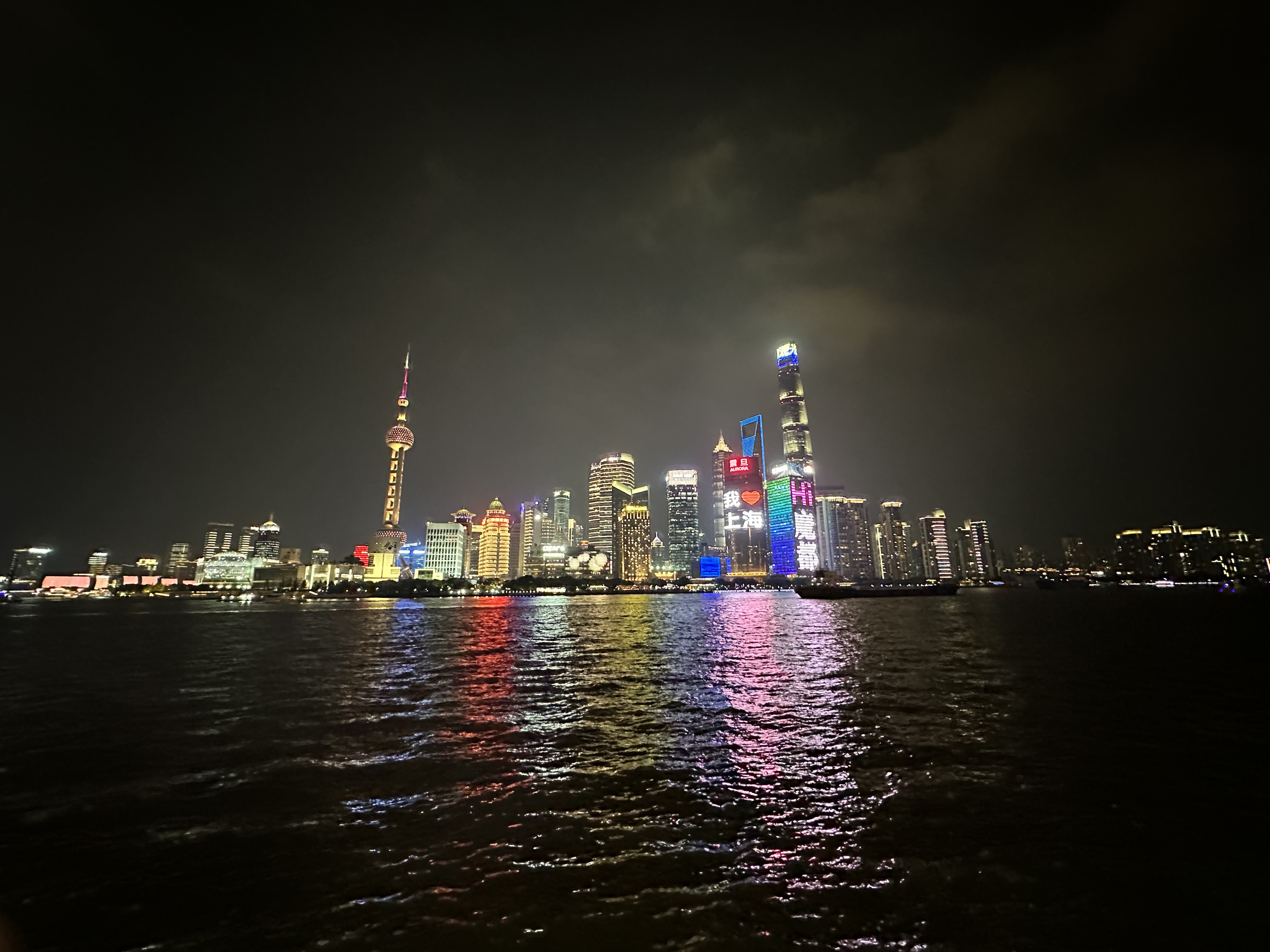 Shanghai's Pudong skyline at night, seen across the Huangpu River from the Bund