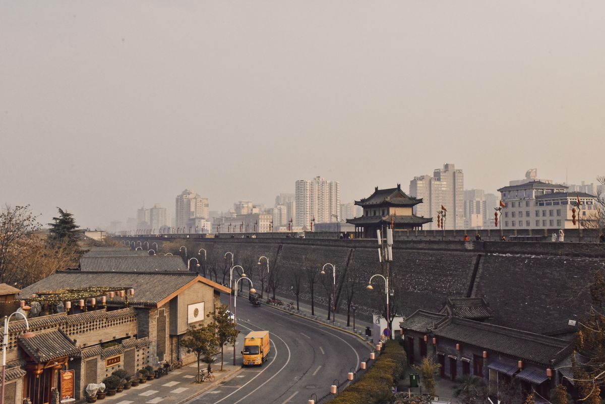 El imponente terraplén gris de la Muralla de Xi'an junto a la ciudad moderna