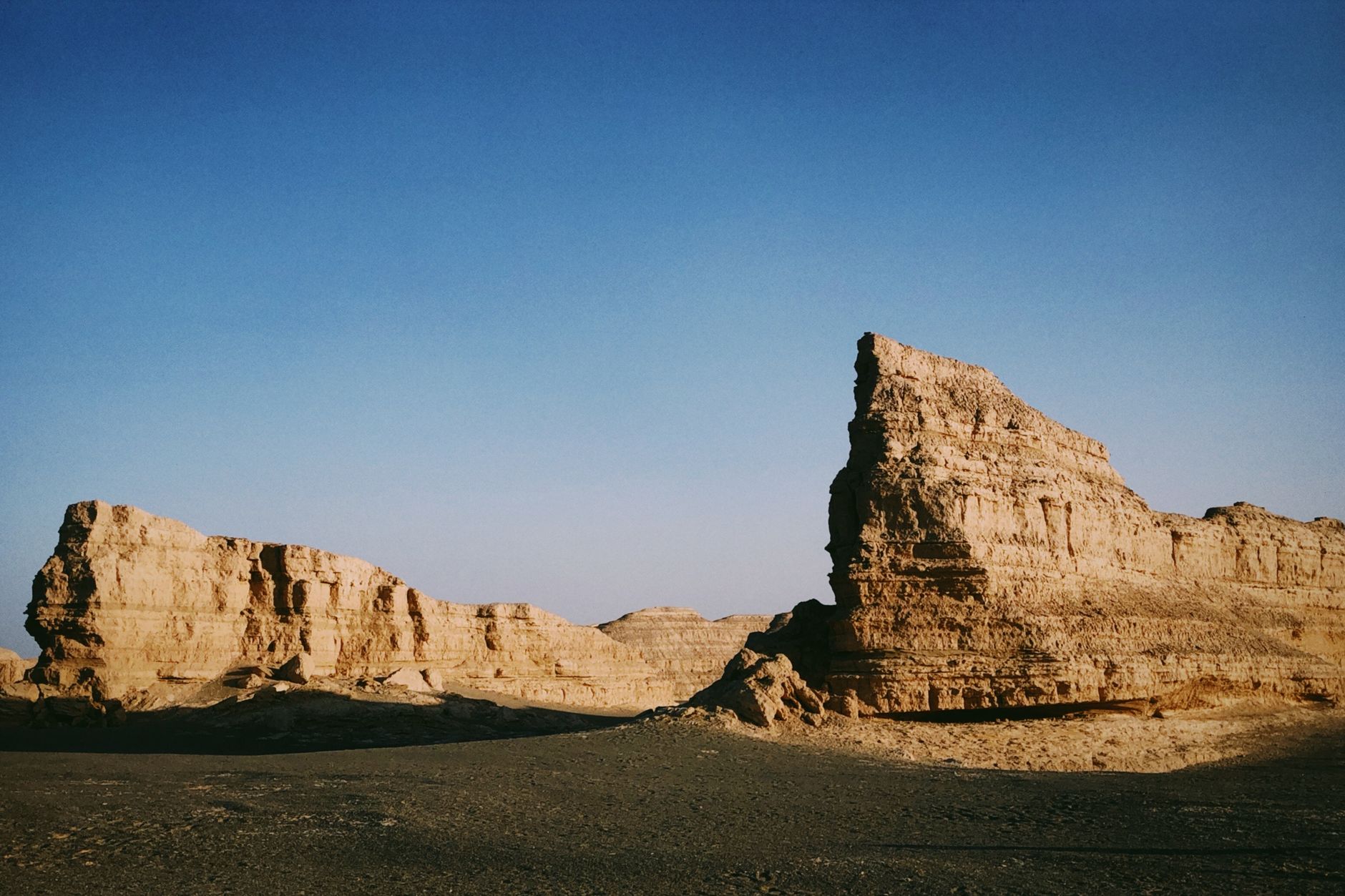 Wind-eroded yardang rock formations rising from the Gobi floor