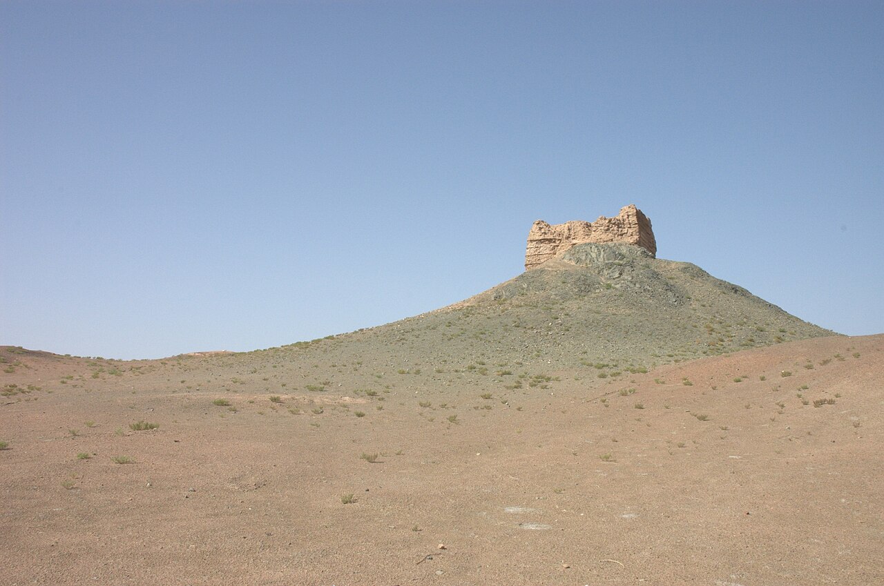 The lone beacon-tower ruin of Yangguan Pass on a Gobi hilltop