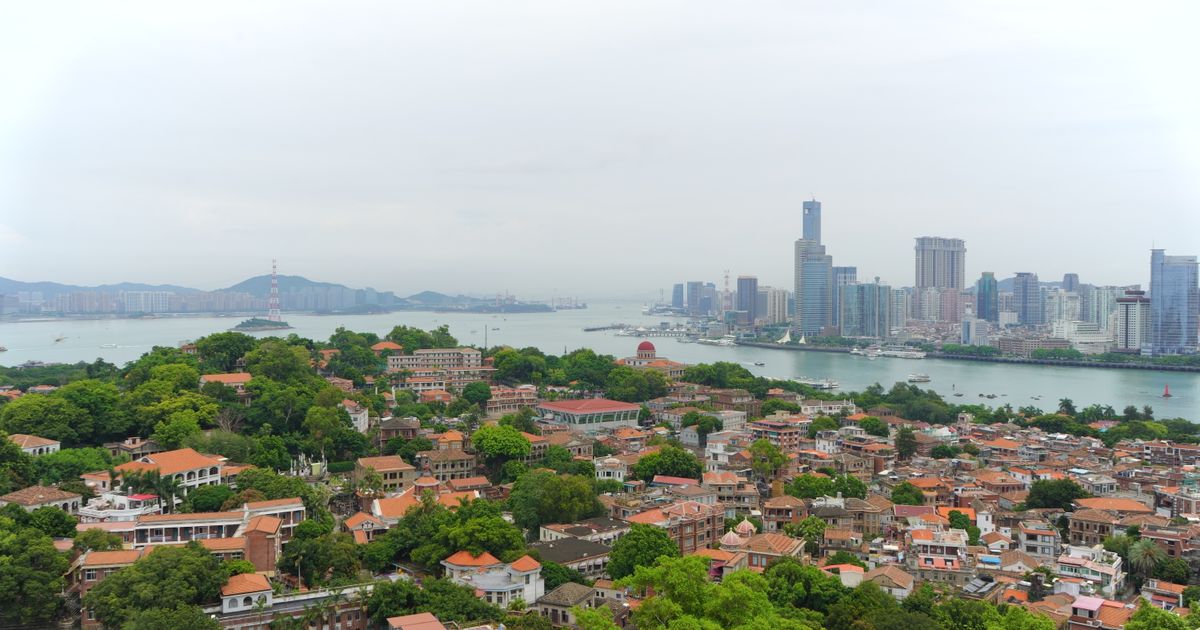 Aerial view of Gulangyu Island and the Xiamen skyline across the water