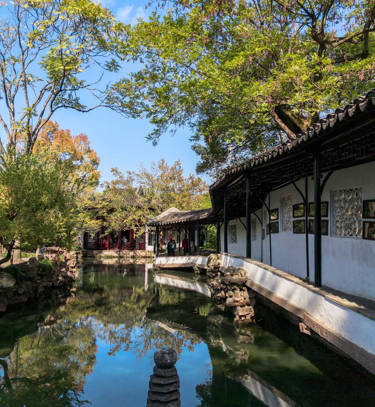 A covered walkway and reflecting pond in a classical Suzhou garden
