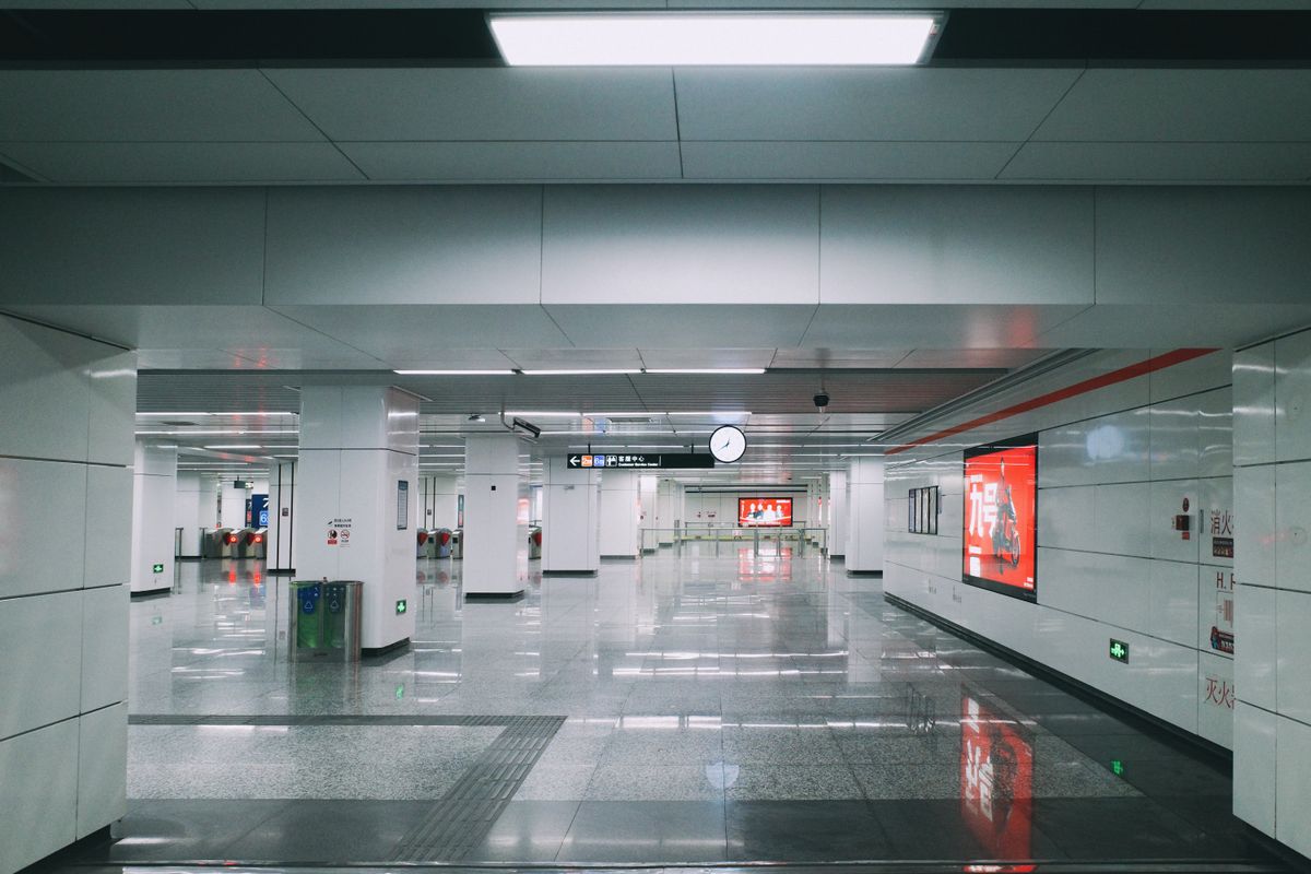 Modern Beijing subway station platform with ticket gates and signage
