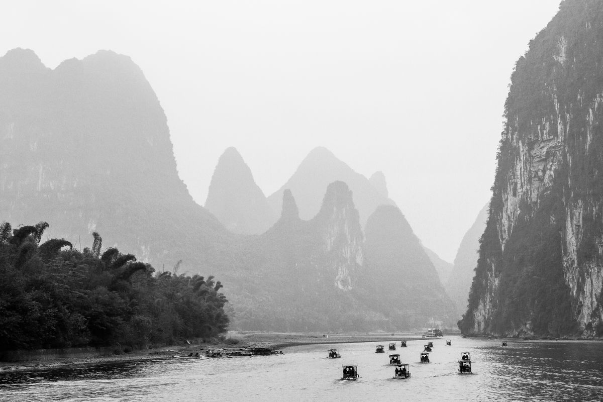 Small tour boats on the Li River near Yangshuo, framed by karst peaks
