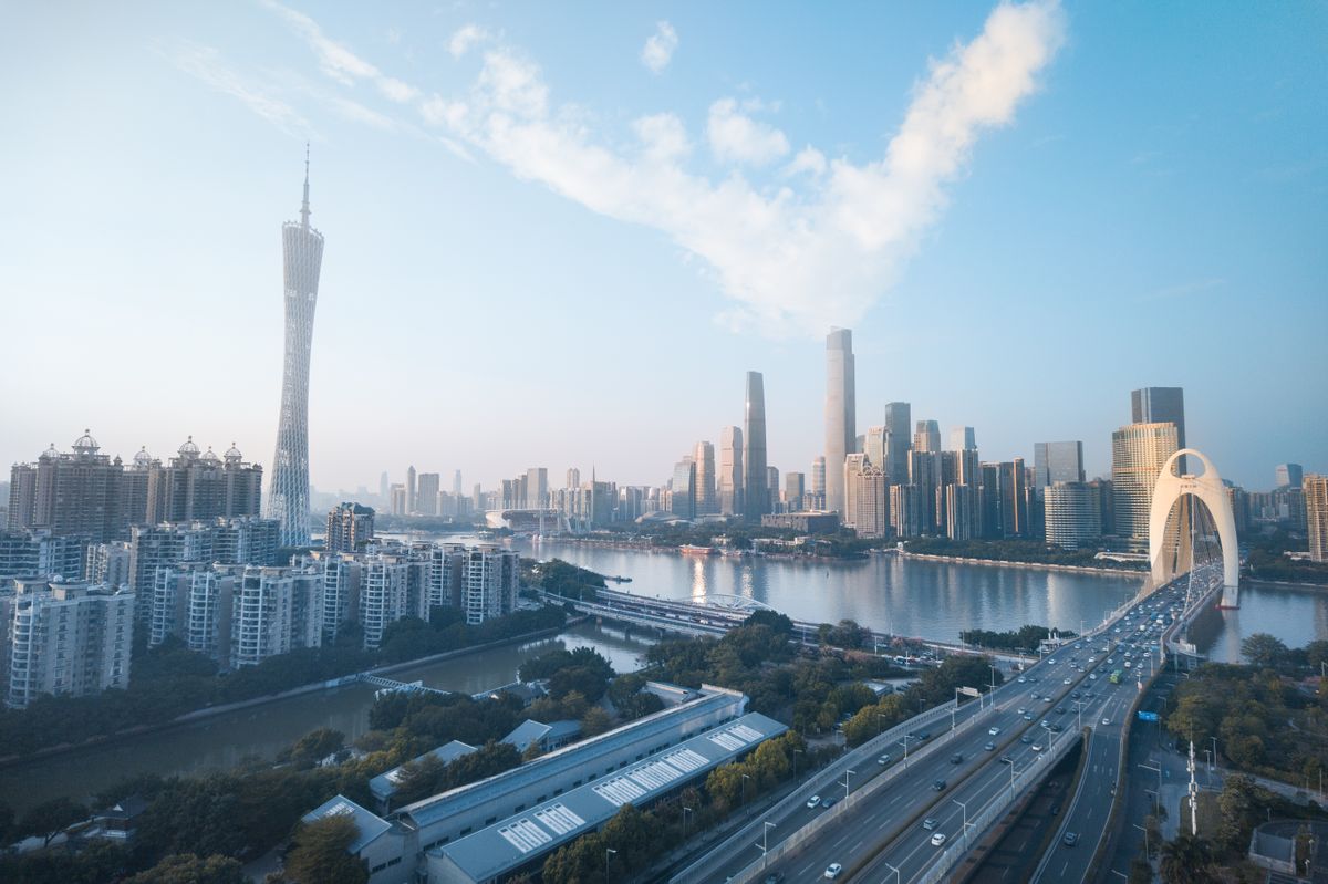 Zhujiang New Town skyline with Canton Tower and Pearl River bridge at dusk