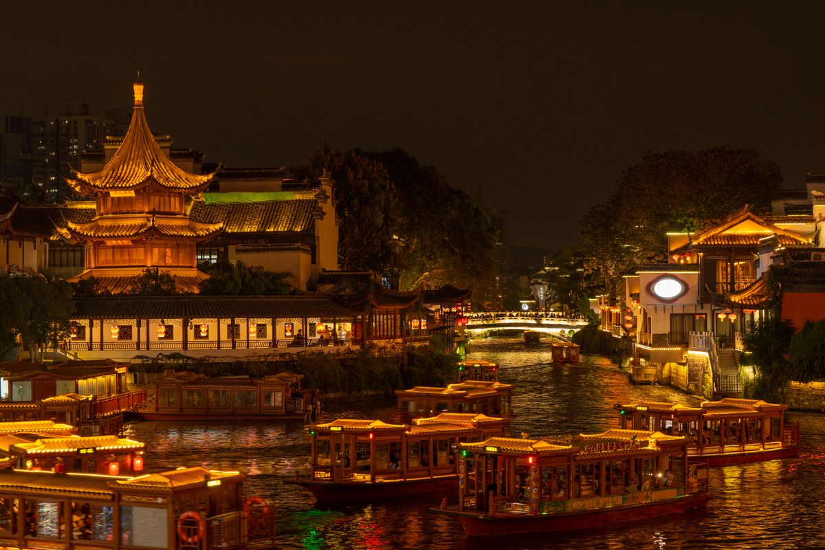 Illuminated boats on the Qinhuai River at night near the Confucius Temple in Nanjing