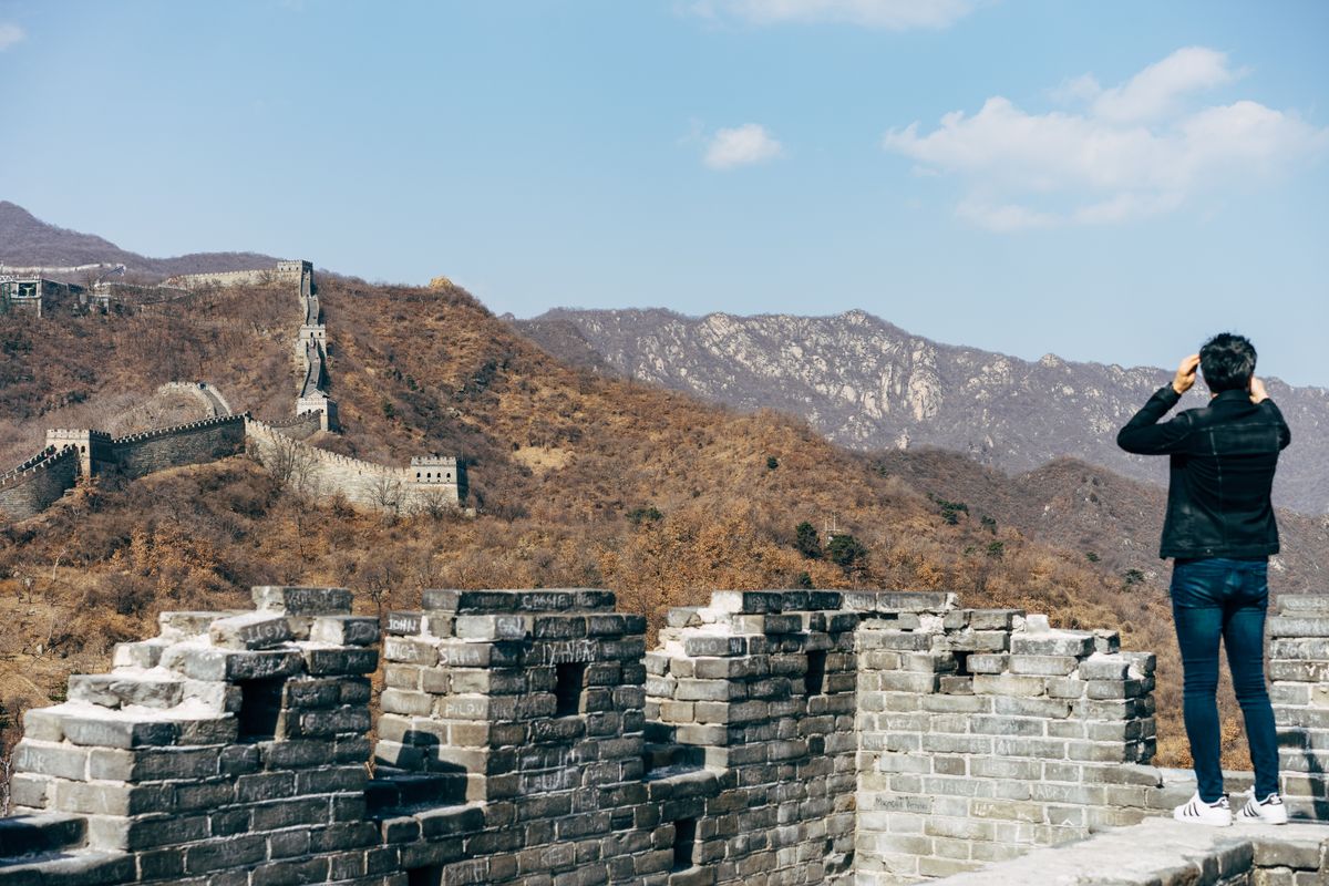 Tourist looking out over the Great Wall of China from a watchtower