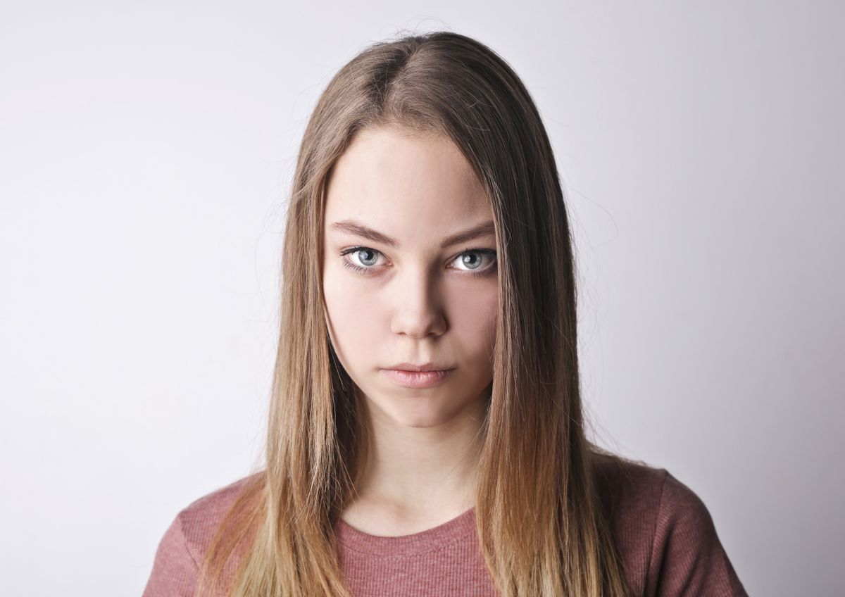 Example of a front-facing photo with a neutral expression against a plain light background