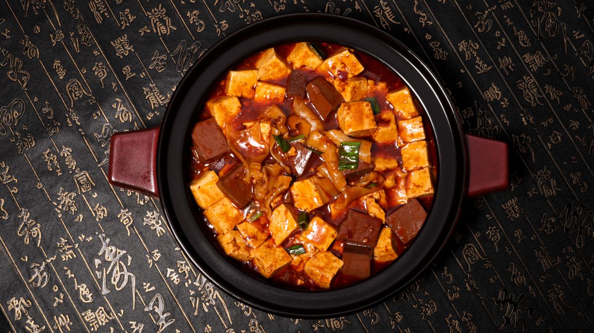 Mapo tofu in a clay pot, a defining Sichuan dish combining chili heat with numbing Sichuan peppercorn