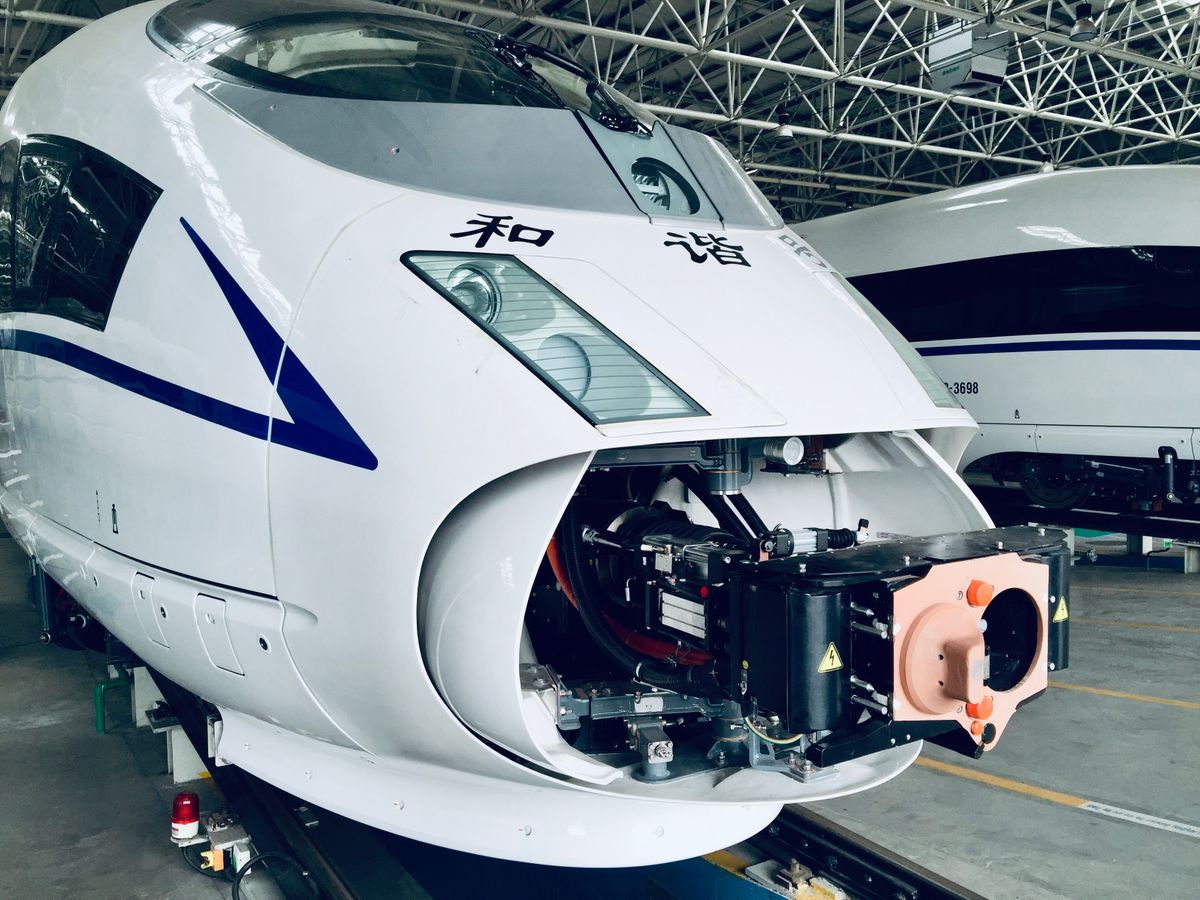 CRH high-speed train nose close-up inside a maintenance depot in China