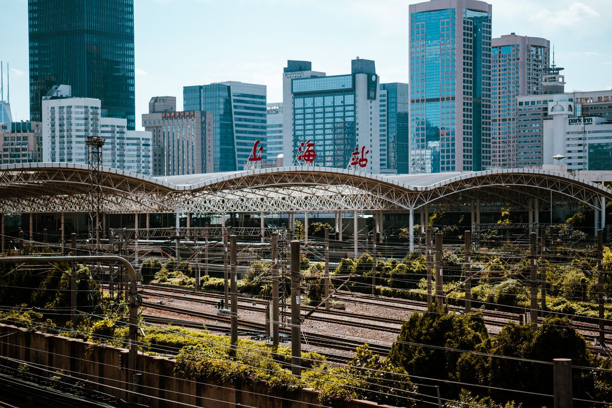 Shanghai Railway Station with high-speed rail tracks and city skyline