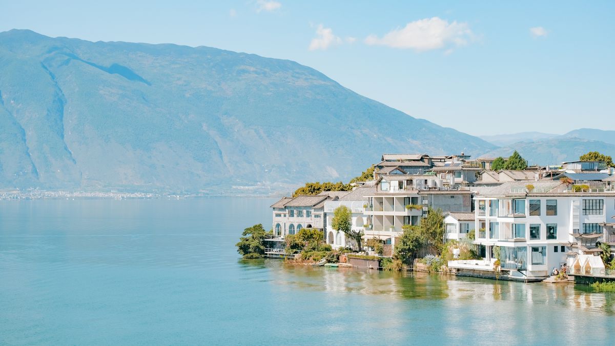 Aerial view of Erhai Lake shoreline homes near Dali with the Cangshan mountains behind, Yunnan, China