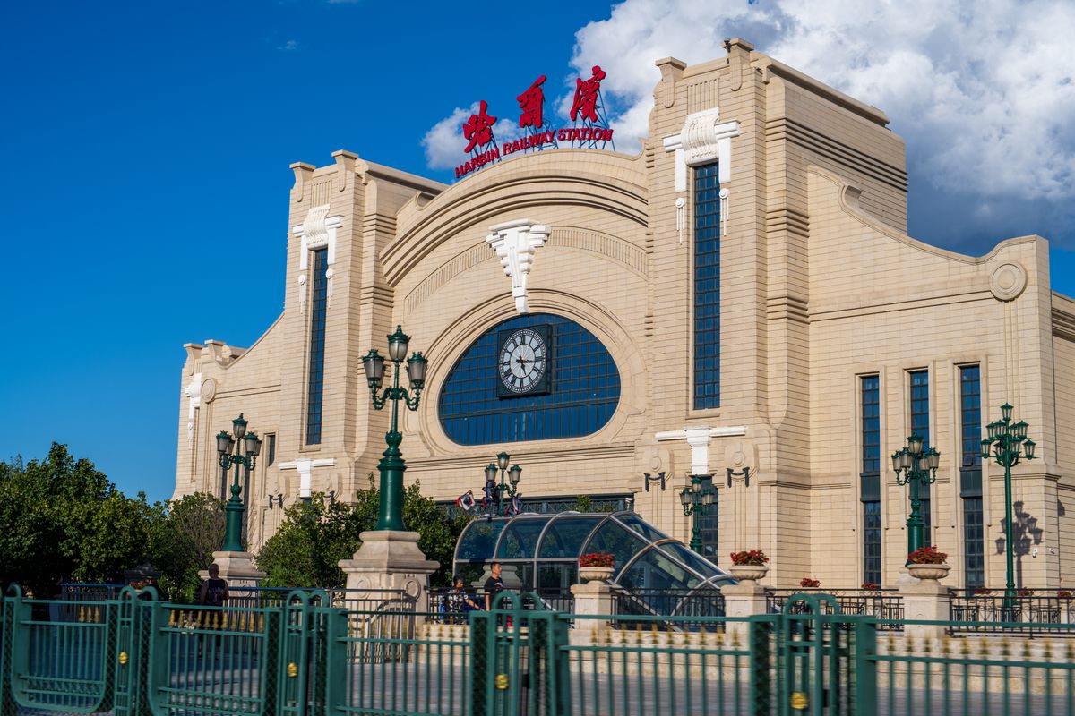 Harbin Railway Station exterior with clock tower and columned entrance