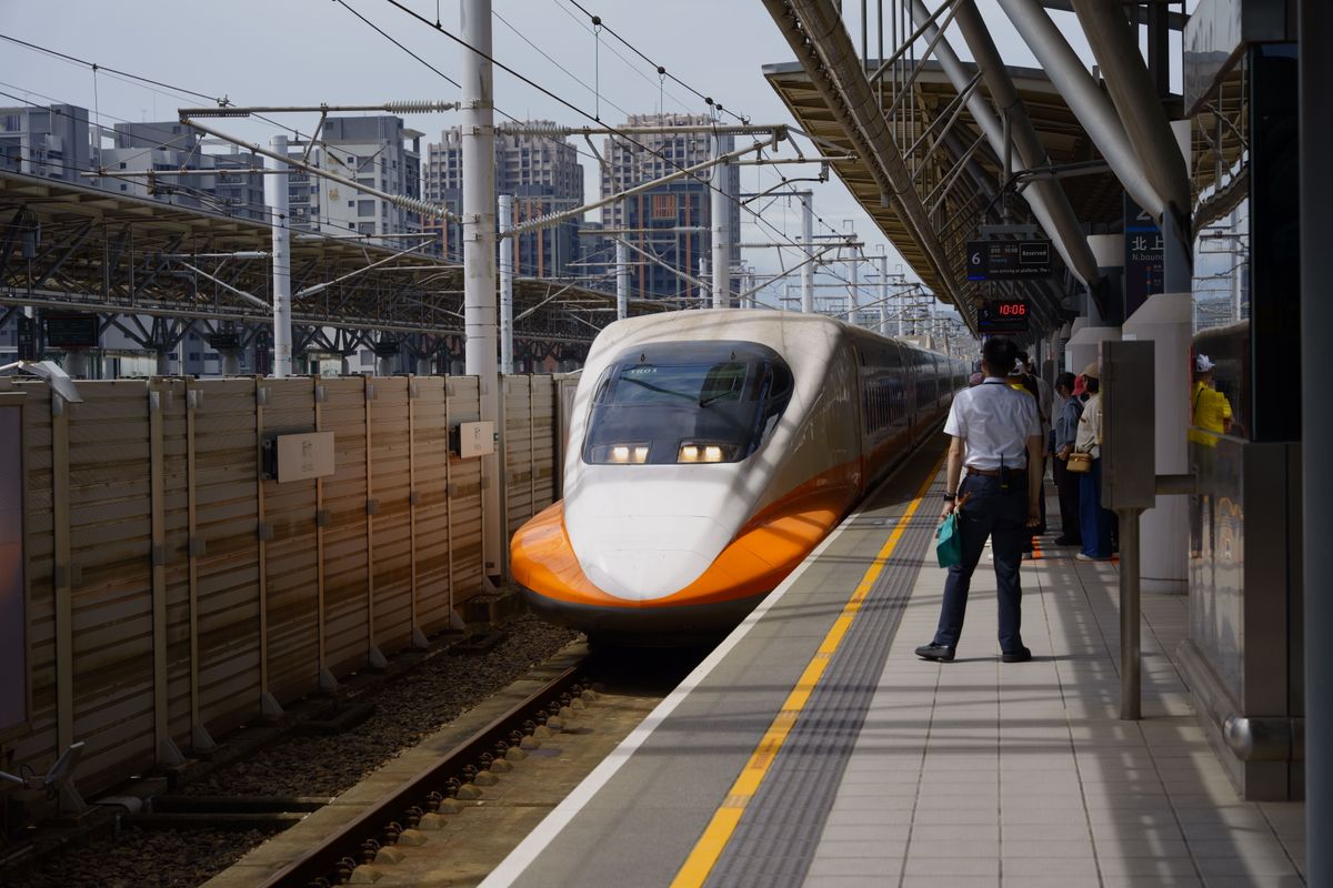 High-speed bullet train arriving at a Chinese railway platform