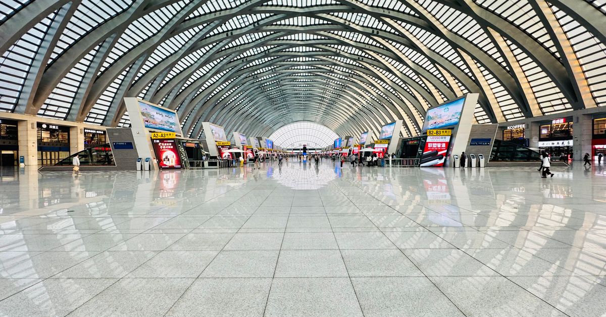 Modern Chinese high-speed rail station interior with departure boards