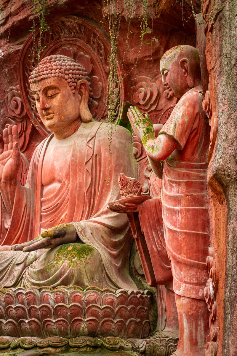 A monk figure carved into the cliffside rock near the Leshan Giant Buddha scenic path