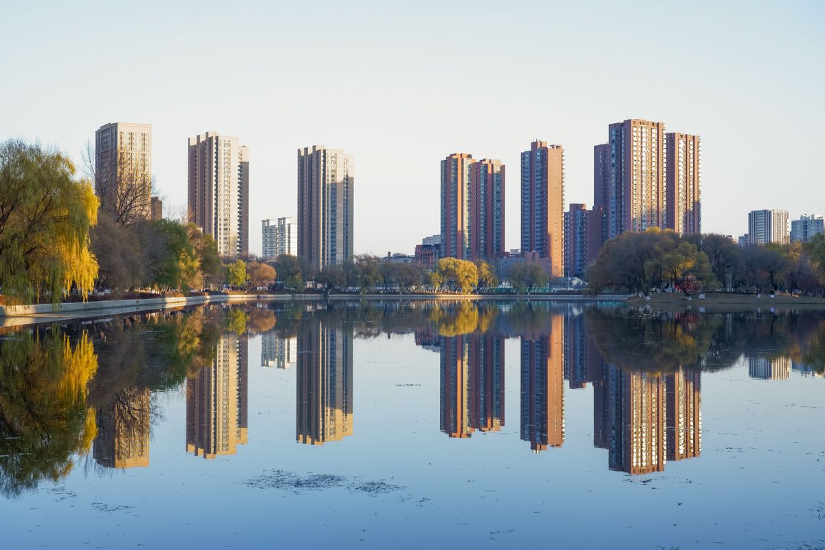 Shenyang's skyline reflected in a city lake