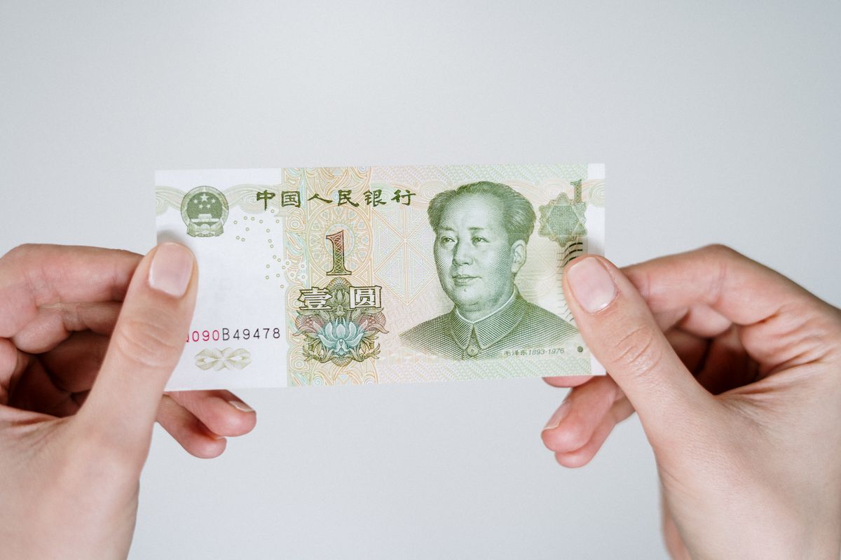 Close-up of hands holding a Chinese yuan banknote