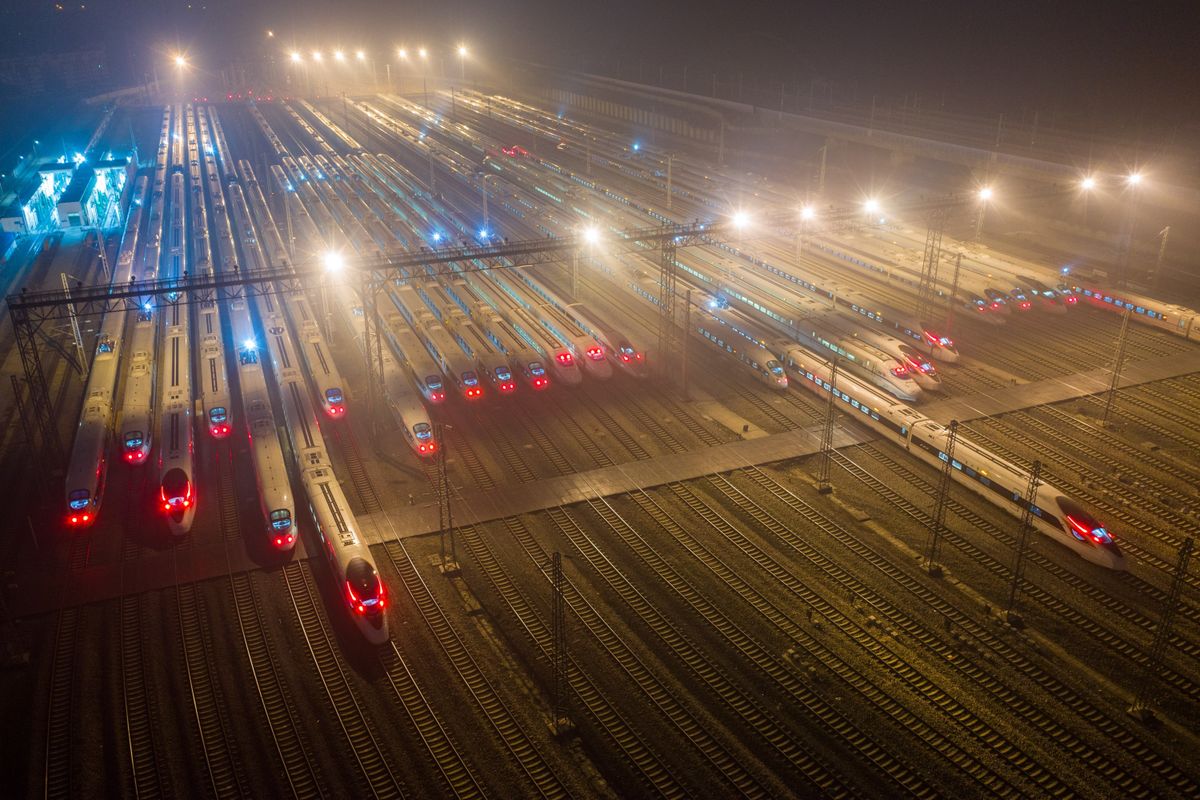 Aerial night view of high-speed trains lined up at a railway depot in China