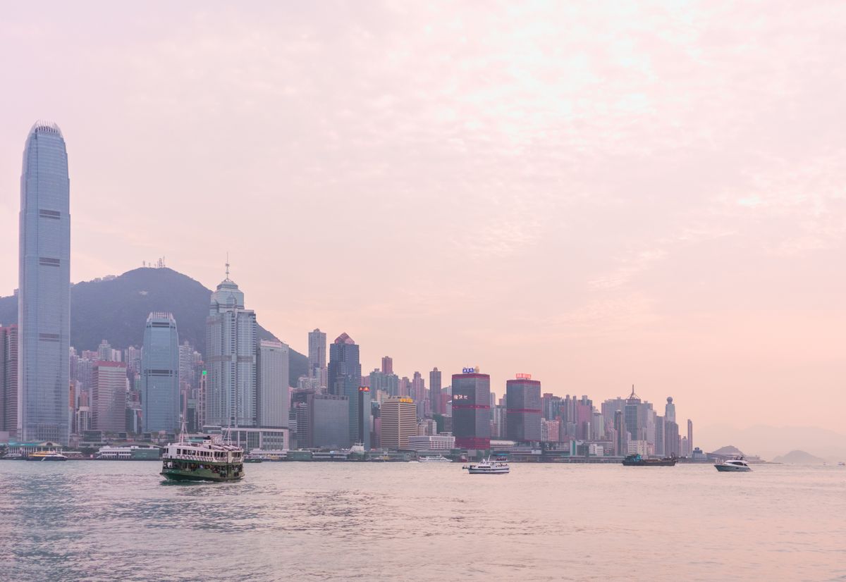 Victoria Harbour at sunset with the Star Ferry and Hong Kong skyline