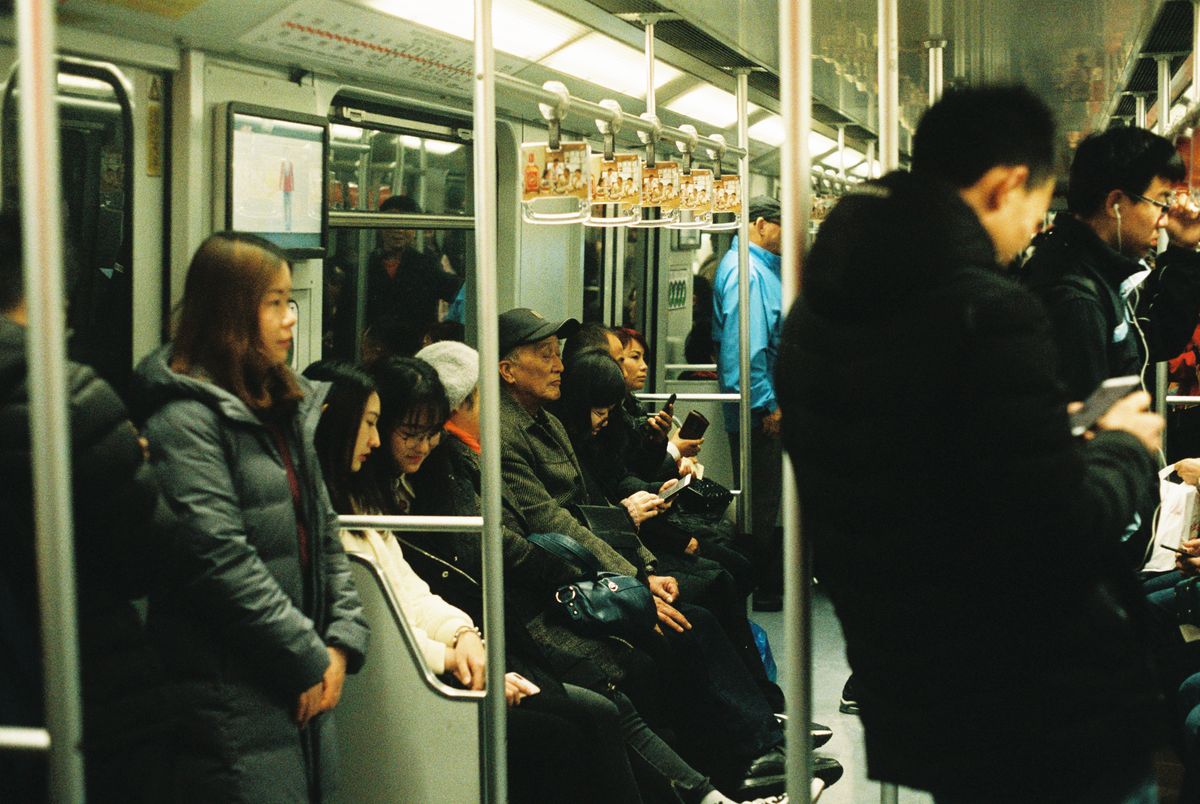 Packed metro carriage with standing passengers during a busy travel period in China