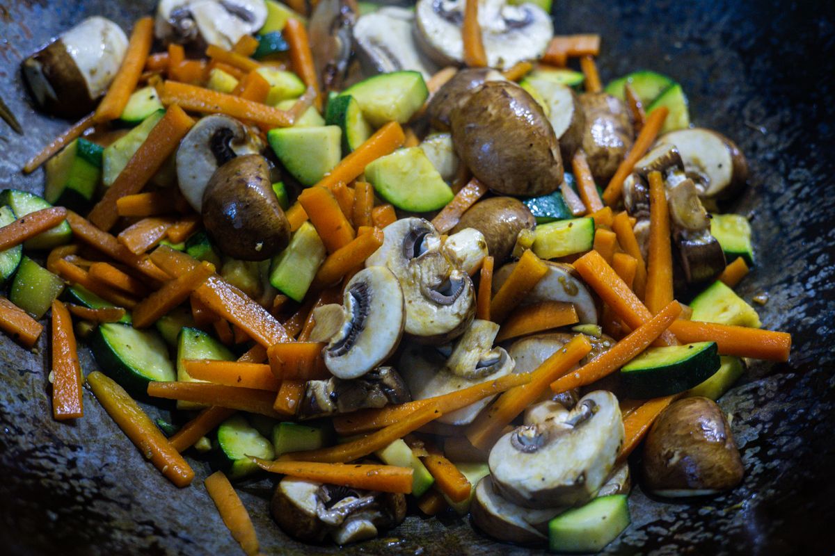 Vegetable and mushroom stir-fry in a wok