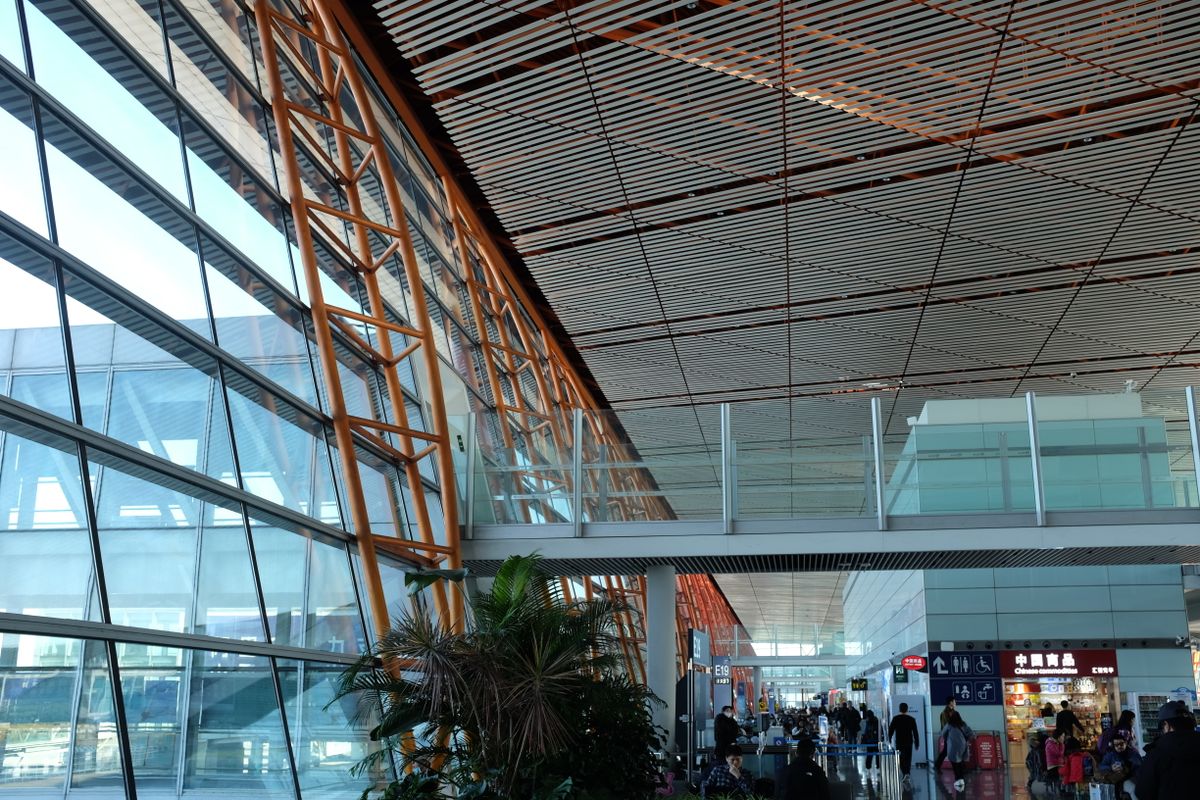 Interior of a modern airport terminal in Beijing with steel roof beams