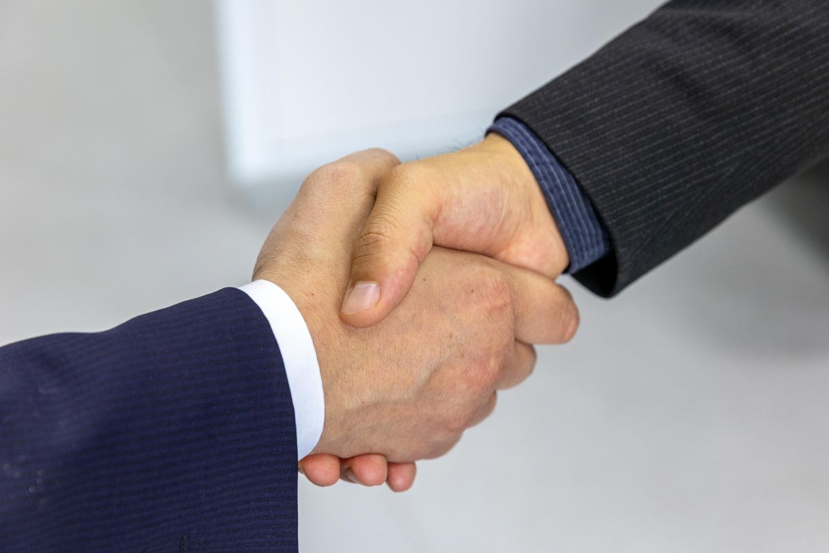 Business handshake between two professionals in an office setting