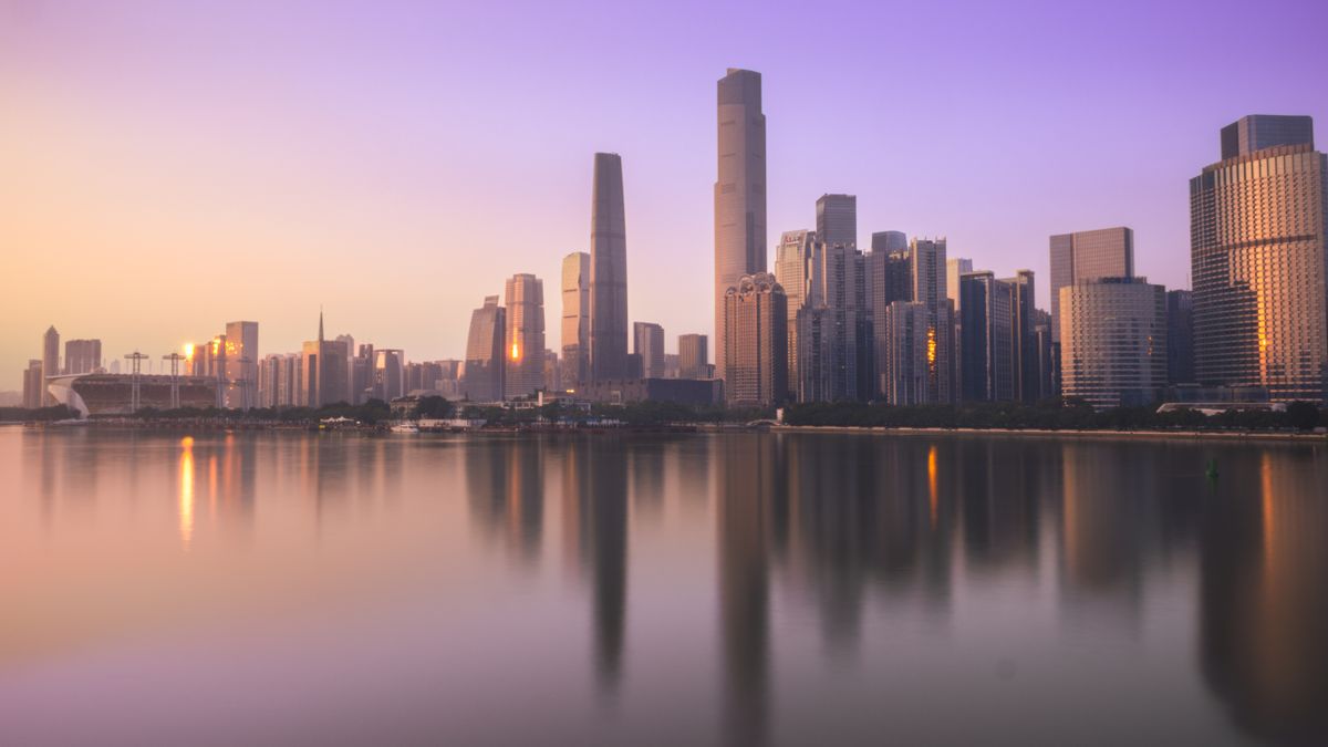 Guangzhou's business district skyline at sunset over the Pearl River