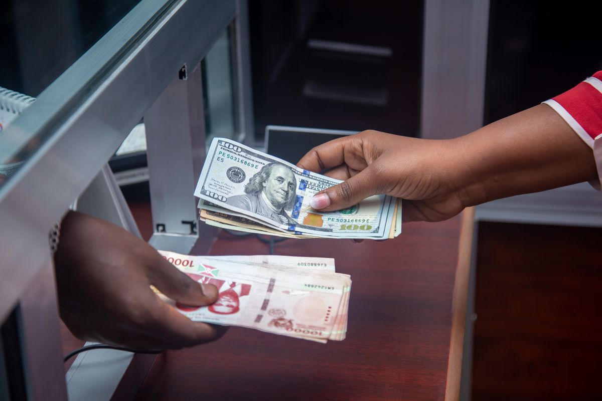 Exchanging currency at a bank counter