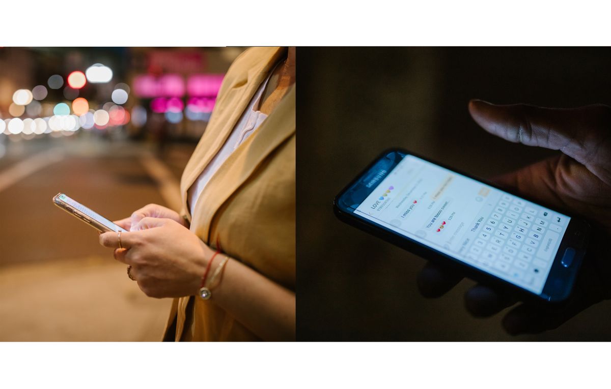 People checking phones on a city street at night