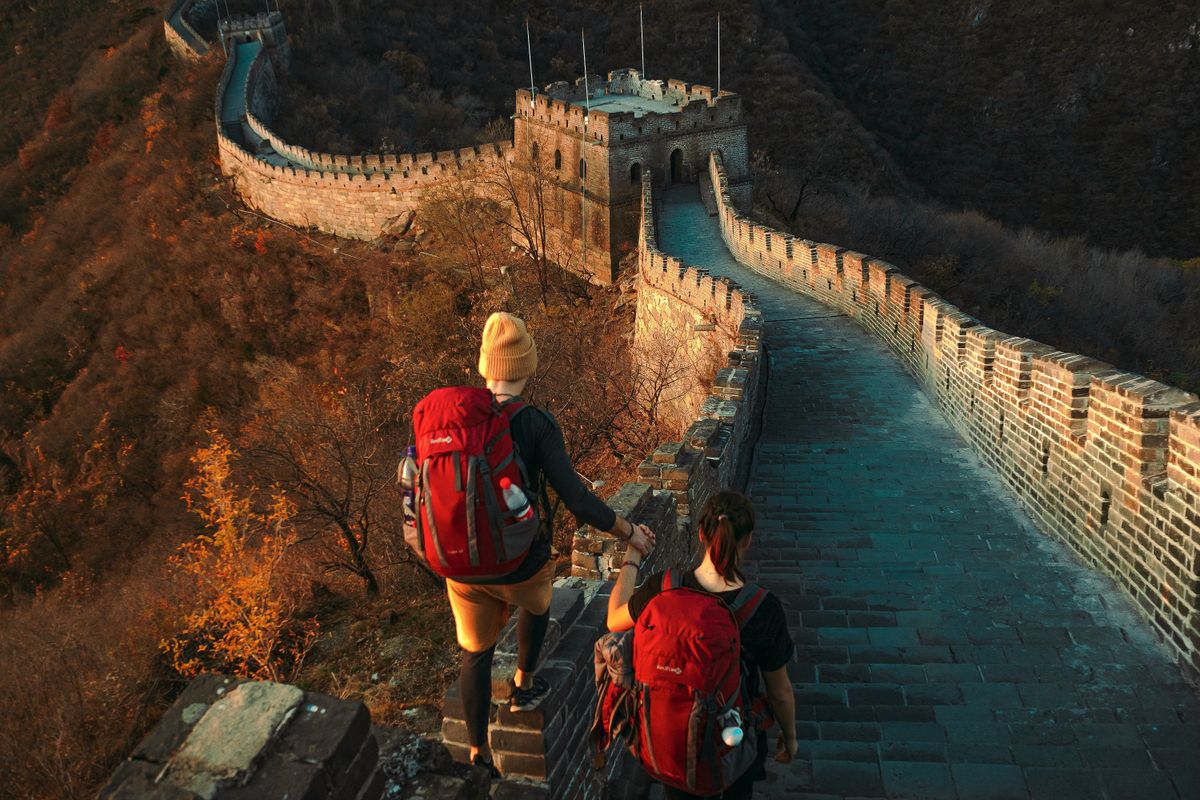 Hikers on the Great Wall at sunset, the kind of remote spot where evacuation cover matters most