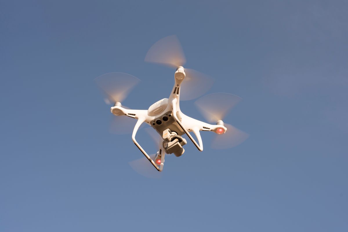 A traveler operating a drone controller