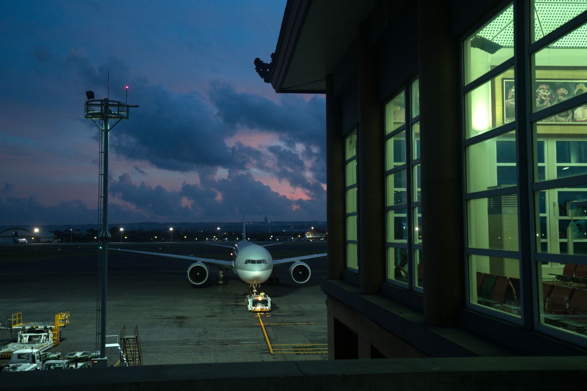 Aircraft waiting at a terminal gate after sunset
