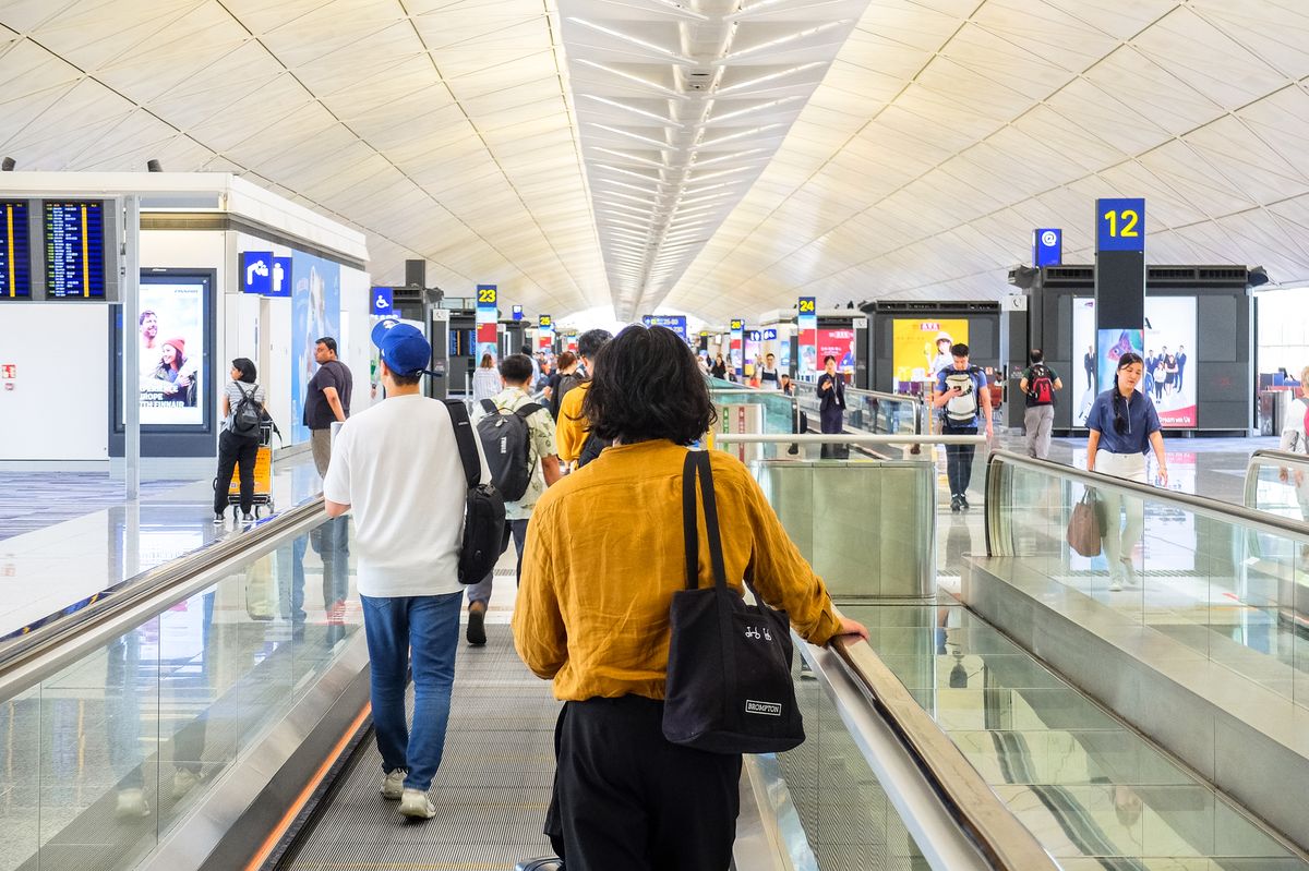 Travelers moving through an international terminal in China