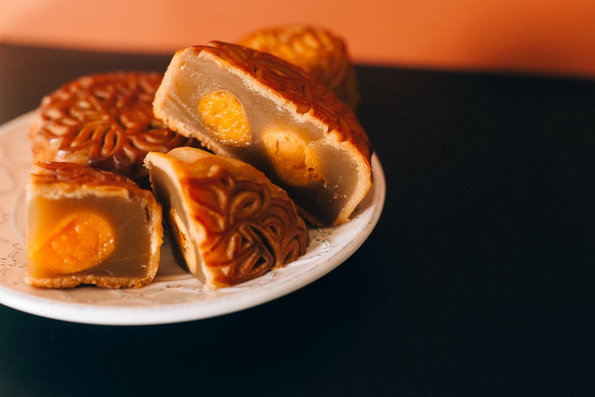 Mooncakes cut open to show salted egg yolk filling