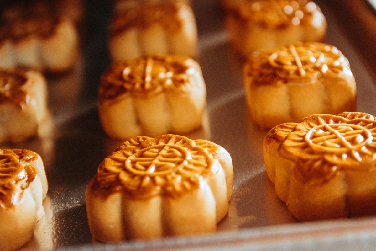 Freshly baked mooncakes cooling on a tray