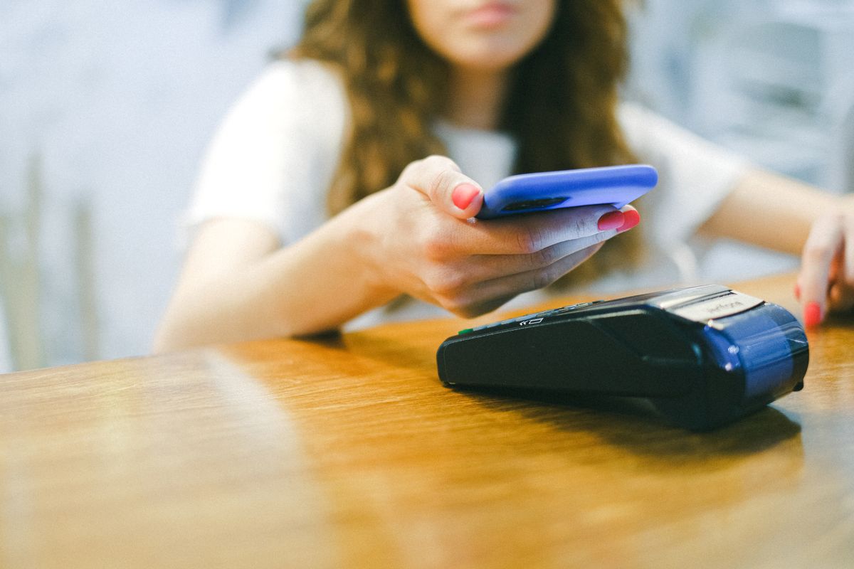 Traveler preparing a mobile payment with a bank card