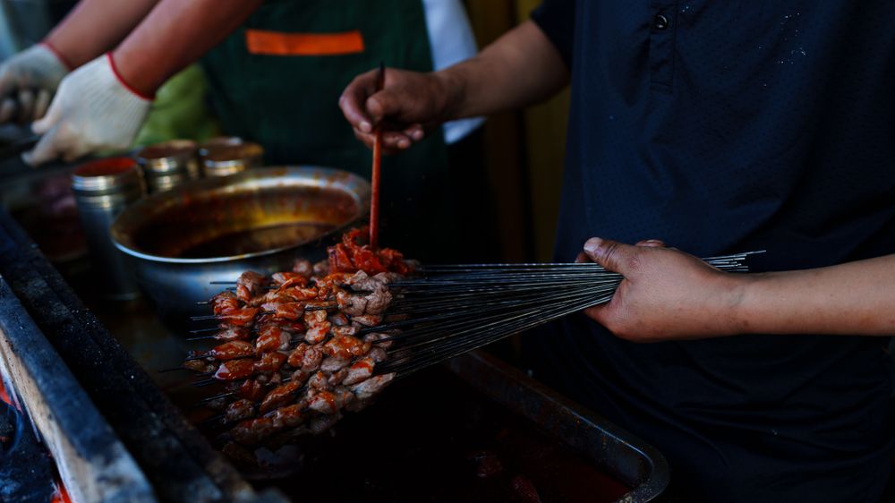 Fresh skewers arranged for grilling at a Chinese market