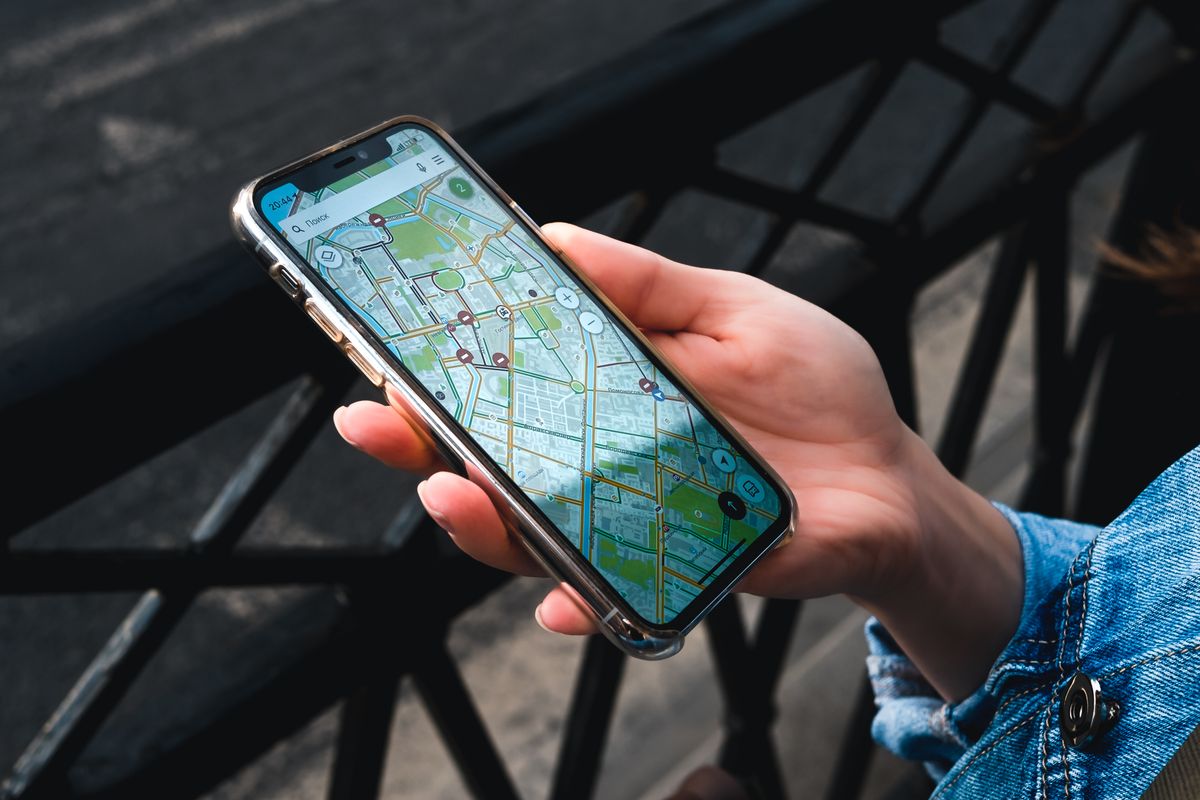 Traveler checking a map app on a phone