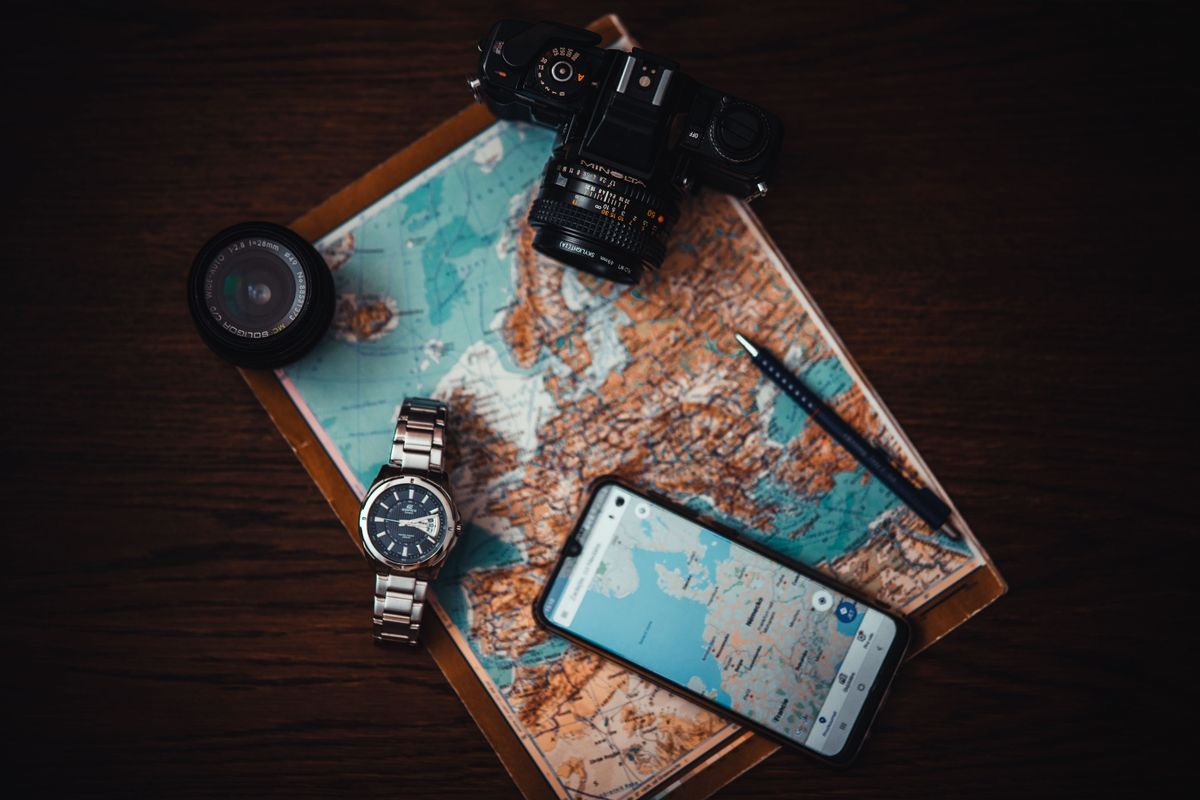 Phone and paper map prepared for a trip