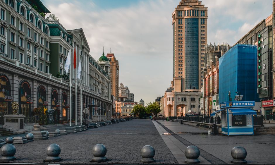 View of Harbin's Central Avenue with classic and modern buildings.