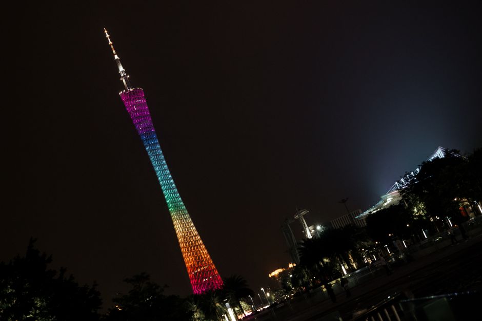 Vibrant night view of the illuminated Canton Tower in Guangzhou against a dark sky.